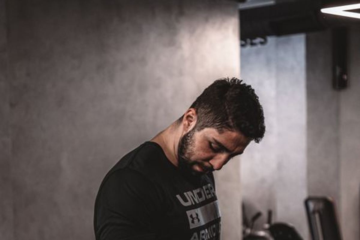 A man exercising alone in a gym.